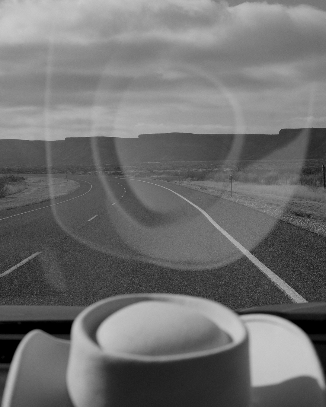 Alone behind the wheel of her car, @caroline.ruffault  explores Texas with the idea of working on the liminal space between bodies and the desert landscapes of the West. But as she travels, the focus shifts: from the body to the car. "The sky is bigger in Texas" is a photographic series centered on the disappearance of the landscape caused by car culture and the ecological disasters it generates in northern Texas.
Caroline Ruffault meets Shuyler Wright, who grew up on a Texas ranch whose mineral rights were sold to an oil company during the 1929 crisis. Today, his family faces the consequences of thousands of abandoned wells: highly toxic water rises to the surface, destroys vegetation, and creates polluted lakes that expand each year. Shuyler is now fighting to strengthen legislation and hold companies accountable in a state where the oil industry remains extremely powerful.

Caroline Ruffault explains: “By immersing my landscape film rolls in produced water from shale gas extraction, I can overlay the reality of destruction onto our idealized images.”

prints by @granondigital 

On view until December 3 at @lantretemps_rennes as part of the @glaz.festival