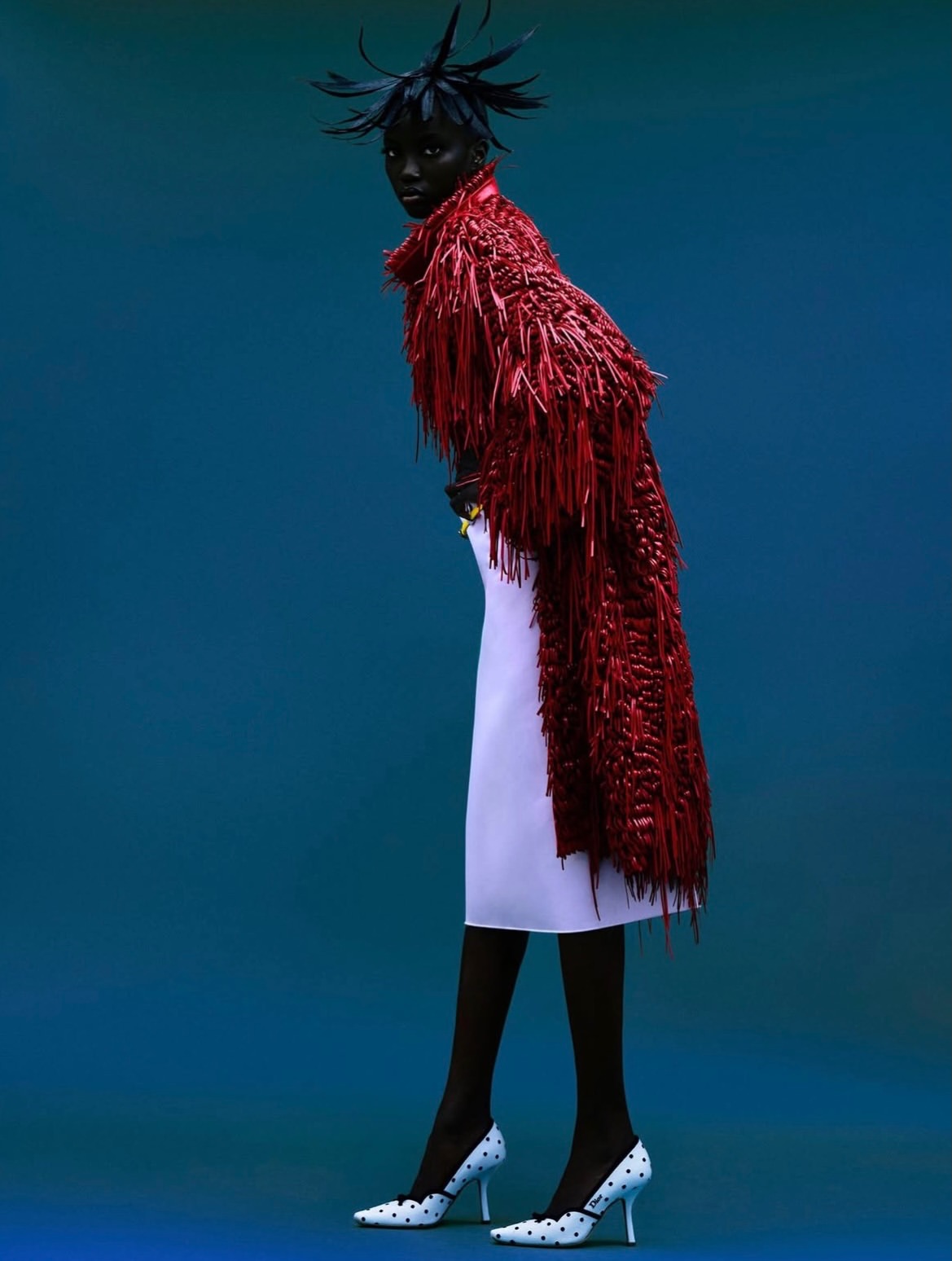 Anok Yai moves through each frame like a vision of...