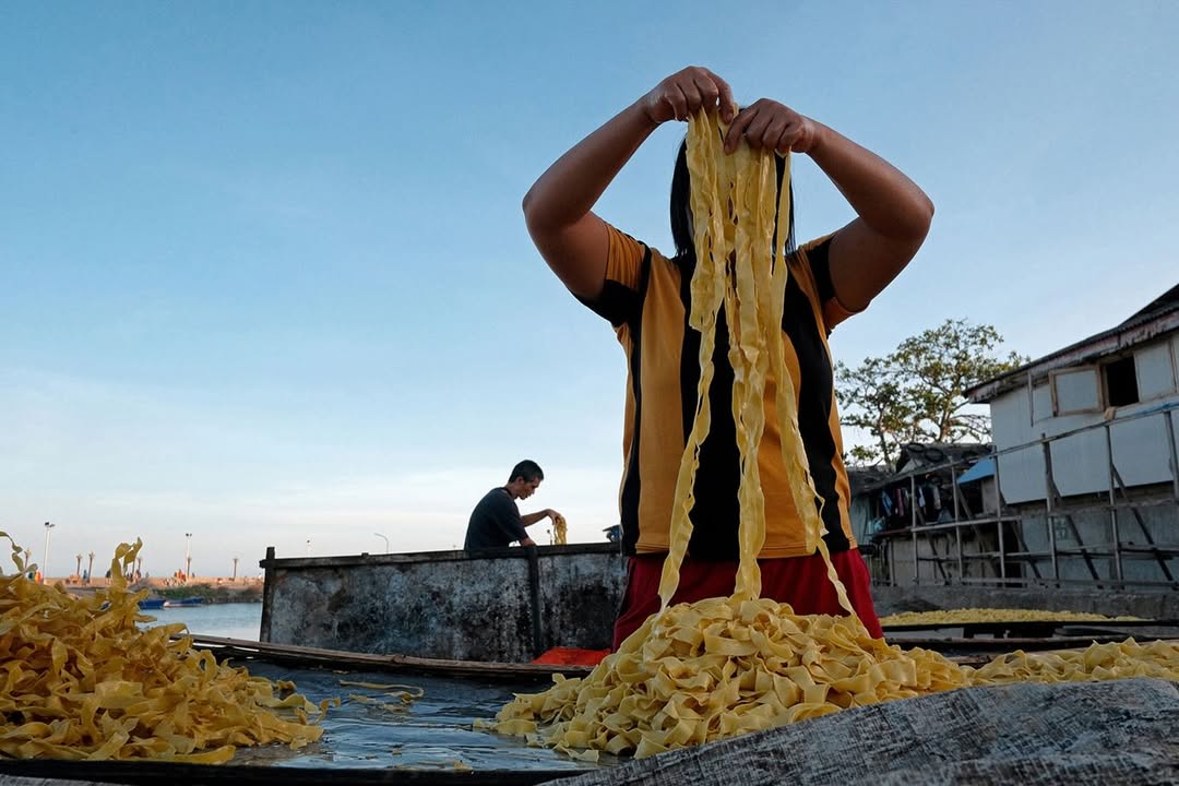 Artist Spotlight: “Catch A Moment” by @hersleyvencasero

This weeks Artist Spotlight features Hersley-Ven Casero, multidisciplinary visual artist and photographer based in Dumaguete City, Philippines. His long-term series, “Catch A Moment” moves through everyday streets and fleeting glances, finding honesty in the uncanny moments that make us deeply human.

“These photographs are not about perfection. They are about presence. I’m chasing a feeling: the rush of kids mid-air above the sea, the hush of light falling through a window, a dog silhouetted against a golden sky, kids playing atop sacks of crimson onions, glowing like jewels, a woman’s face caught twice in one moment, real and reflected. Every frame is a quiet witnessing, a heartbeat stilled in time.

Drawn to the poetry of the everyday, I look for the magic in the mundane: in the warmth of sunlit walls, in shadows cast by strangers, in the choreography of street life unfolding without warning. This is where stories live, where life pulses loudest in its smallest, most honest gestures.

Catch A Moment is my way of honoring what most might walk past. It is not about capturing the perfect shot. It is about capturing the true one, the kind that stirs something in you, the kind you feel before you fully see.”