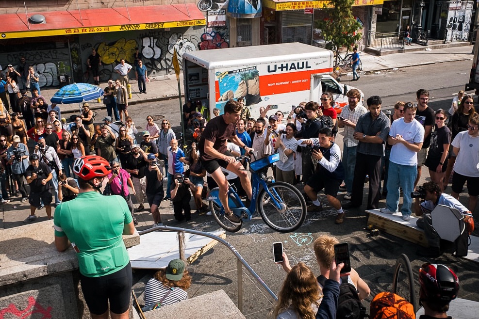 Scenes from @citybikeboys’ gloriously chaotic 4th annual Citi Bike Day, captured from above, below, and every angle in between.
This past Saturday, hundreds of New Yorkers took to the city’s iconic blue commuter bikes to race across the Williamsburg Bridge, clear some makeshift ramps, and hopefully claim the $1,500 prize. Part spectacle and part communal adrenaline rush, this event brought out a sense of camaraderie that can only come from watching a stranger risk a very public wipeout simply for the thrill of it.
Spearheaded by skater, designer, and musician @j3rom3, the day encapsulated the kind of wonderfully unruly, people-powered mayhem that makes the city feel so alive.
Photographs by:
Ian Bartlett (@thebartlett)
Kyle Young (@408kyle)
Rory Mulhere (@rorymulhere)
Ellie Keane (@ellieekeane)
Zach Buchner (@zachbnyc)