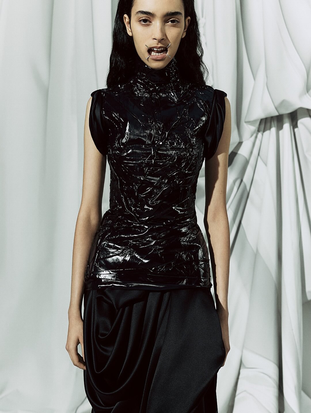 Maison Margiela Co-Ed SS26, Paris Fashion Week

At the recent Paris Fashion Week, Glenn Martens revealed his first ready-to-wear collection for Maison Margiela, following his debut at the Haute Couture show last July.
The collection immediately made an impression, notably with the four metal bars that stretched the models’ mouths, reminiscent of dental retractors, yet shaped in the brand’s iconic Four Stitches motif.
Tailoring was reinvented this season with innovative shoulder constructions, ultra-low-rise trousers, and jackets with tie closures. The runway also showcased striking textures: 16th-century floral wallpaper prints recreated on knitwear, tops made from fused and recycled vintage jewelry, silk jackets and coats fully coated in plastic for a waterproof effect, knitted plastic fabrics, and corsets and shoulder details on certain dresses.
For his debut show, Glenn Martens offered “fresh design ideas alongside reimagined and evolved pieces from the archives, crafted by the entire Maison Margiela team.”

Creative Direction @maisonmargiela @glennmartens
Styling @ursinagysi
Make Up @ingegrognard
Hair @garygillhair
Nails @cam.t.artist
Backstage Photographer @melanie_ramon 
Post House @sheriff.projects
#sheriffprojects