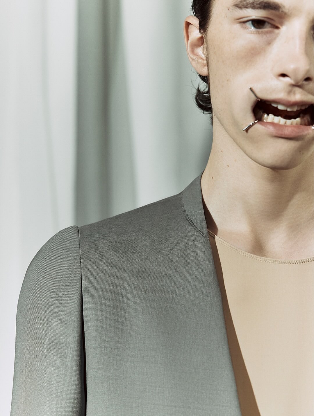 Maison Margiela Co-Ed SS26, Paris Fashion Week

At the recent Paris Fashion Week, Glenn Martens revealed his first ready-to-wear collection for Maison Margiela, following his debut at the Haute Couture show last July.
The collection immediately made an impression, notably with the four metal bars that stretched the models’ mouths, reminiscent of dental retractors, yet shaped in the brand’s iconic Four Stitches motif.
Tailoring was reinvented this season with innovative shoulder constructions, ultra-low-rise trousers, and jackets with tie closures. The runway also showcased striking textures: 16th-century floral wallpaper prints recreated on knitwear, tops made from fused and recycled vintage jewelry, silk jackets and coats fully coated in plastic for a waterproof effect, knitted plastic fabrics, and corsets and shoulder details on certain dresses.
For his debut show, Glenn Martens offered “fresh design ideas alongside reimagined and evolved pieces from the archives, crafted by the entire Maison Margiela team.”

Creative Direction @maisonmargiela @glennmartens
Styling @ursinagysi
Make Up @ingegrognard
Hair @garygillhair
Nails @cam.t.artist
Backstage Photographer @melanie_ramon 
Post House @sheriff.projects
#sheriffprojects