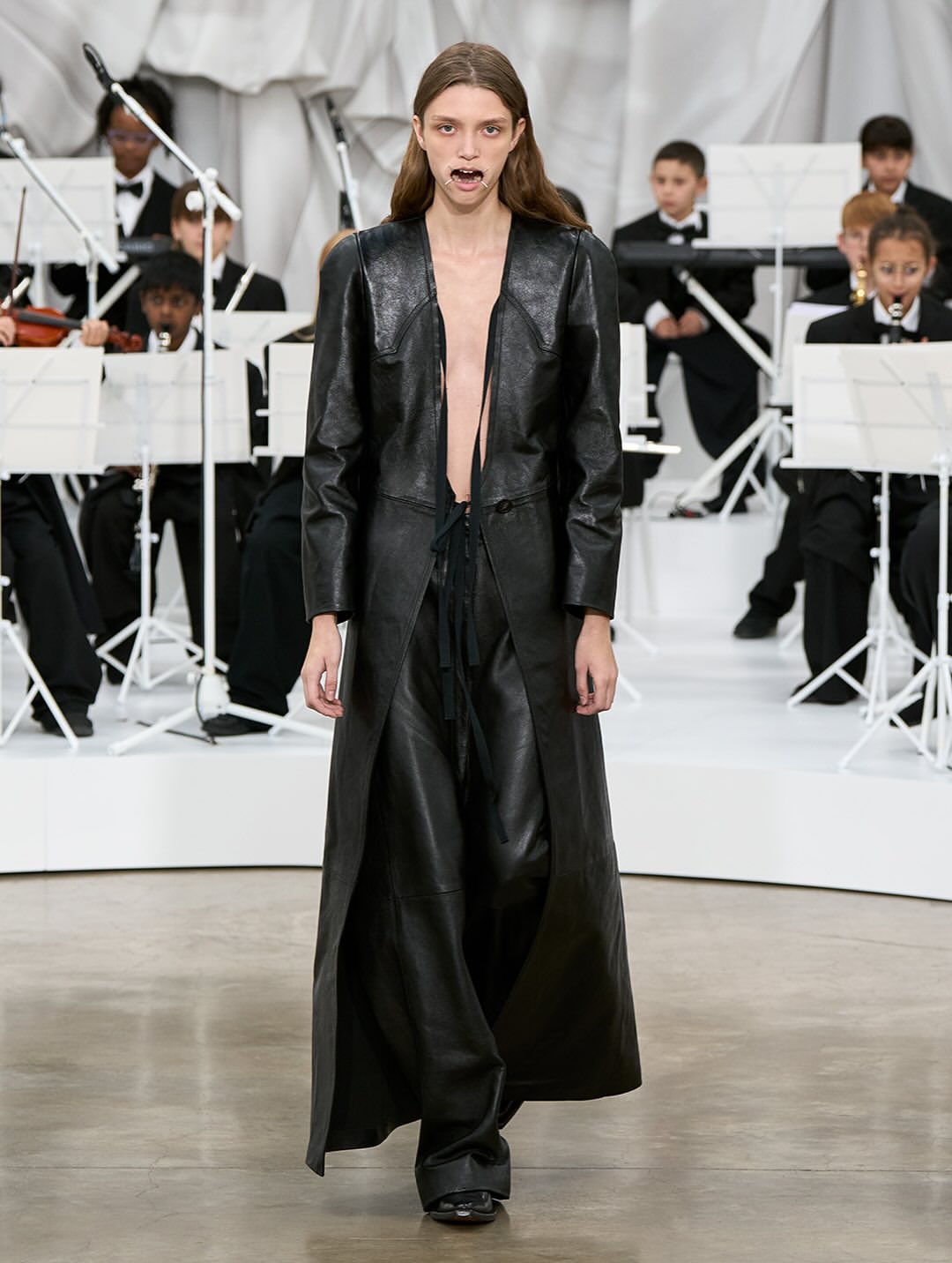 Maison Margiela Co-Ed SS26, Paris Fashion Week

At the recent Paris Fashion Week, Glenn Martens revealed his first ready-to-wear collection for Maison Margiela, following his debut at the Haute Couture show last July.
The collection immediately made an impression, notably with the four metal bars that stretched the models’ mouths, reminiscent of dental retractors, yet shaped in the brand’s iconic Four Stitches motif.
Tailoring was reinvented this season with innovative shoulder constructions, ultra-low-rise trousers, and jackets with tie closures. The runway also showcased striking textures: 16th-century floral wallpaper prints recreated on knitwear, tops made from fused and recycled vintage jewelry, silk jackets and coats fully coated in plastic for a waterproof effect, knitted plastic fabrics, and corsets and shoulder details on certain dresses.
For his debut show, Glenn Martens offered “fresh design ideas alongside reimagined and evolved pieces from the archives, crafted by the entire Maison Margiela team.”

Creative Direction @maisonmargiela @glennmartens
Styling @ursinagysi
Make Up @ingegrognard
Hair @garygillhair
Nails @cam.t.artist
Backstage Photographer @melanie_ramon 
Post House @sheriff.projects
#sheriffprojects