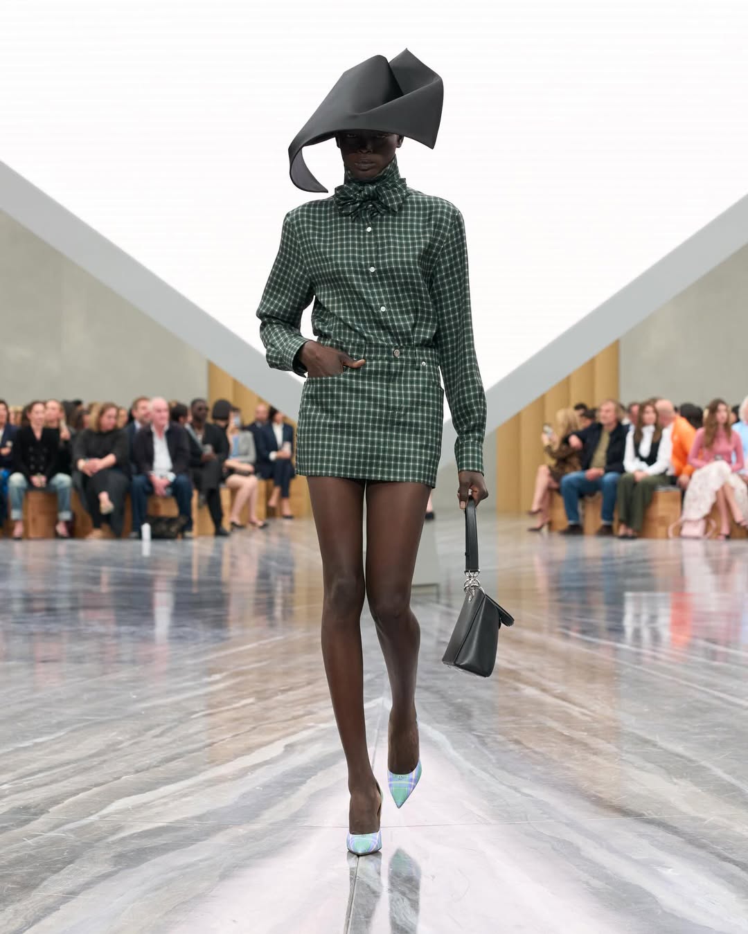 Dior SS26, Paris Fashion Week

During the latest Paris Fashion Week, Jonathan Anderson unveiled his first womenswear collection for Dior. The show opened with an Adam Curtis–directed short film projected on a pyramidal screen, tracing Dior’s creative legacy, from Christian Dior’s floral silhouettes to Galliano’s theatrical flair, while paying homage to Maria Grazia Chiuri’s artistic influence.
Models appeared from behind an open Dior archival box, wearing reimagined classics infused with Anderson’s postmodern, surreal touch. The opening look, a white dress echoing Dior’s 1952 “Cigale” design, set the tone with exaggerated bows and sculptural shapes. Throughout, Anderson intertwined his own aesthetic with the house’s heritage, blending historical drama with contemporary edge: peplum blazers paired with frayed denim, transparent gowns over nude bodysuits, and voluminous caban coats. Stephen Jones’s origami hats and rose-toe shoes completed a collection that elegantly bridged Dior’s past and Anderson’s avant-garde vision.

Creative Direction @dior @jonathan.anderson
Styling @benjaminbruno_
Make Up @peterphilipsmakeup
Hair @guidopalau
Backstage Photographer @mireia_deulofeu
Post House @sheriff.projects
#sheriffprojects